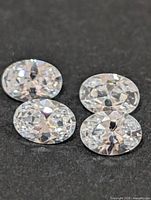 Four oval cubic zirconia gemstones close-up