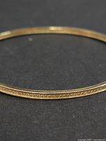 Full view of bangle showing channel-set stones