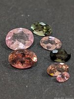 Group of seven faceted oval tourmaline stones of assorted colours