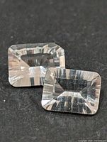 Pair of rectangular faceted white topaz stones front view