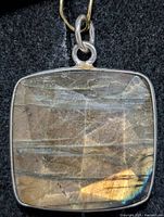 Front view of square labradorite pendant in silver setting