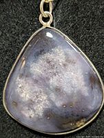 Front view of dendritic agate pendant in silver bezel