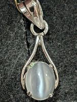Front view showing moonstone cabochon and silver frame