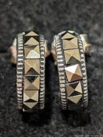 Front view of both earrings showing marcasite pyramid stones and milgrain border