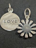 Round disc pendant with LOVE engraving and daisy flower pendant