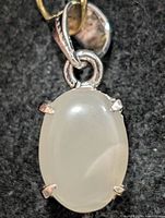 Front view of oval moonstone pendant in silver setting