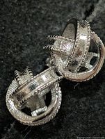 front view of silver knot earrings