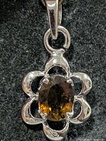 Front view showing smoky quartz and silver floral frame