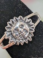 front view of ring showing sun face design