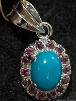 Front view showing turquoise cabochon and surrounding garnets