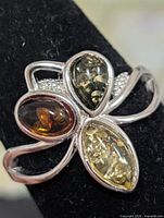 Front view showing three amber stones and silver setting