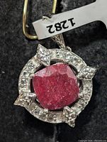 front view showing ruby center and topaz halo