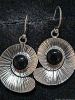 Front view of both silver spiral earrings showing onyx stones and texture