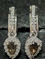 Front view showing both earrings with smoky quartz centers and CZ halo