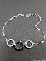 Full view of bracelet showing chain, clasp, interlocking rings