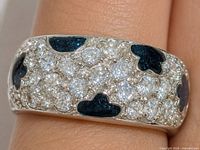 Ring on finger showing pave CZ and blue clover enamel design