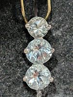 Front view of pendant showing all three blue topaz stones and bail