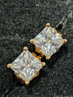close-up of both earrings displaying stones and prong settings