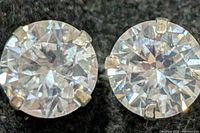 Front view of both CZ stud earrings showing round stones and prong settings