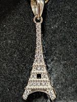 Front view of silver Eiffel Tower pendant with CZ stones