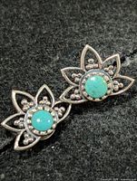 Front view showing lotus design and turquoise stones