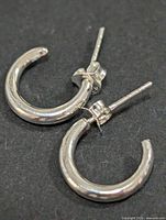 Close-up of both hoop earrings showing overall design and finish