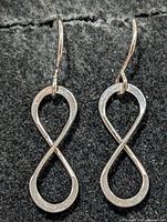 Front view of both earrings showing infinity design