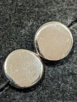 Front view of both round silver stud earrings