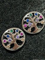 Front view of both earrings showing tree motif and multicoloured stones