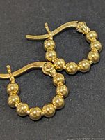 front view of both beaded hoop earrings showing bead pattern and latch backs