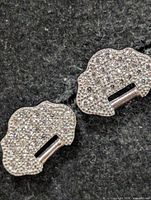 front view of both cloud-shaped pavé earrings