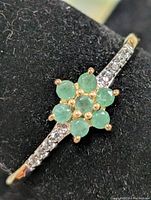 Close-up of emerald cluster and CZ shoulder accents