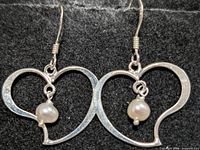 Front view of both earrings showing heart shape and pearls