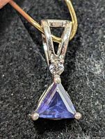 Front view showing trillion-cut iolite, clear accent stone and V-shaped bail