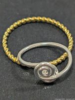 twisted rope band ring and open spiral ring, side by side