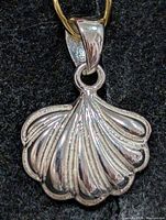 front view of silver scallop shell pendant showing overall design