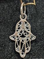 Front view of silver filigree Hamsa pendant