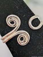 Close-up of ring face showing dual spiral design
