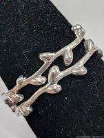Front view of silver branch design ring on mandrel