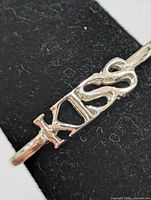 Front view showing “KISS” design on band