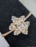 Close-up of ring face showing marquise center and surrounding stones
