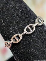 Close-up of ring on display showing anchor-link design