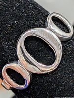Front view showing three open ovals design on ring