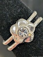Front view showing flower design and center stone