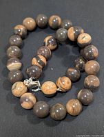 Full view of zebra jasper necklace showing bead coloration and clasp