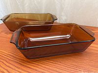 Two amber glass loaf pans on tabletop showing overall form