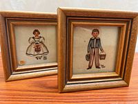Both framed paintings side by side