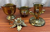 Group view of four decorative metal items