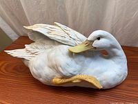 Left side of ceramic swan showing full body and wing detail