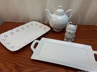 Group shot of teapot, cat creamer and two trays